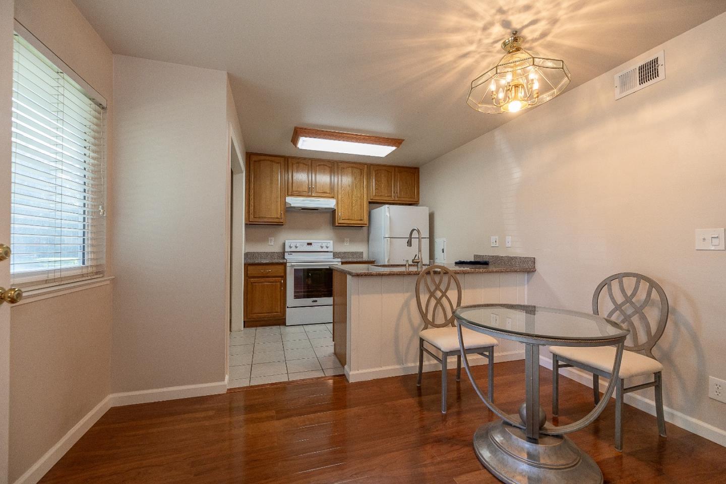207 Watson Drive, Unit 1 Campbell, CA 95008 - Photo 5 of 17 a kitchen with refrigerator and cabinets