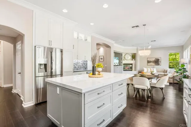 a living room with furniture large window and a fireplace