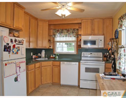45 Kimberly Road Colonia, NJ 07067 - Photo 2 of 10 a kitchen with granite countertop white cabinets and white appliances