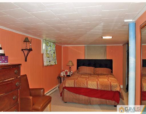 45 Kimberly Road Colonia, NJ 07067 - Photo 5 of 10 a bedroom with a bed and wooden floor