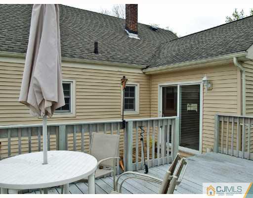 45 Kimberly Road Colonia, NJ 07067 - Photo 8 of 10 a backyard of a house with table and chairs