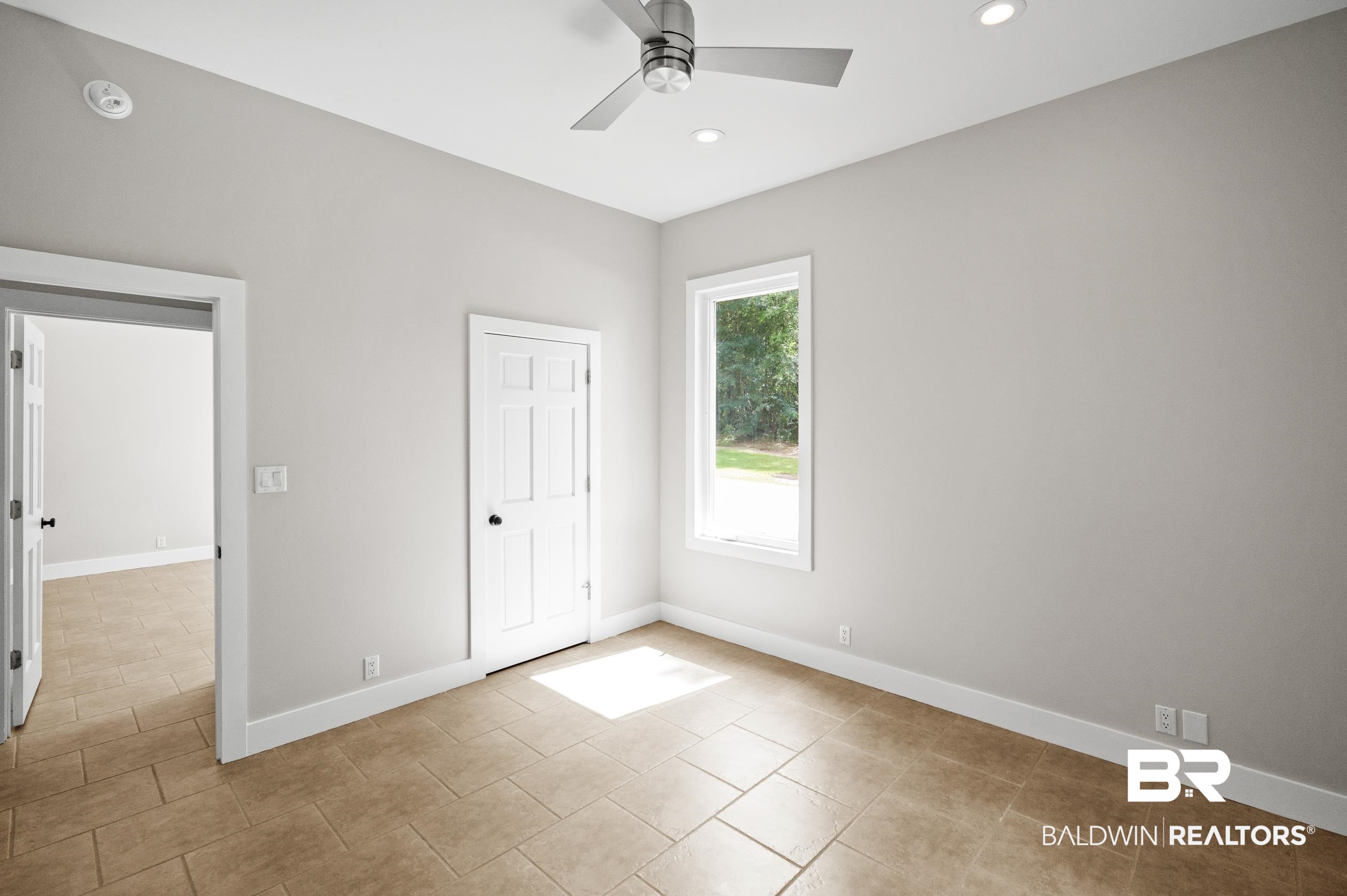 15031 Timber Ridge Drive Loxley, AL 36551 - Photo 33 of 43 Unfurnished bedroom featuring a closet, light tile patterned floors, and ceiling fan