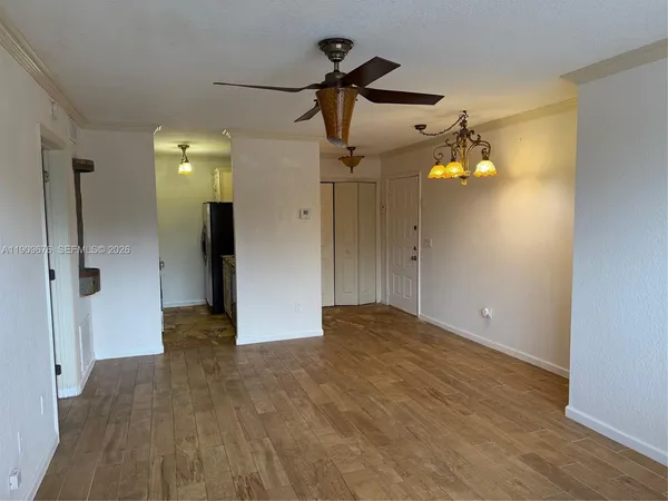 a view of empty room with wooden floor