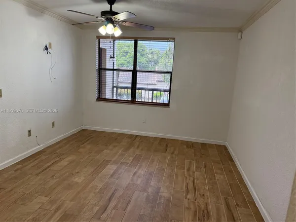 wooden floor in an empty room with a window