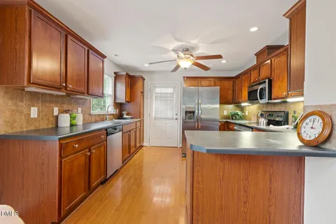 a kitchen with granite countertop wooden cabinets and a sink