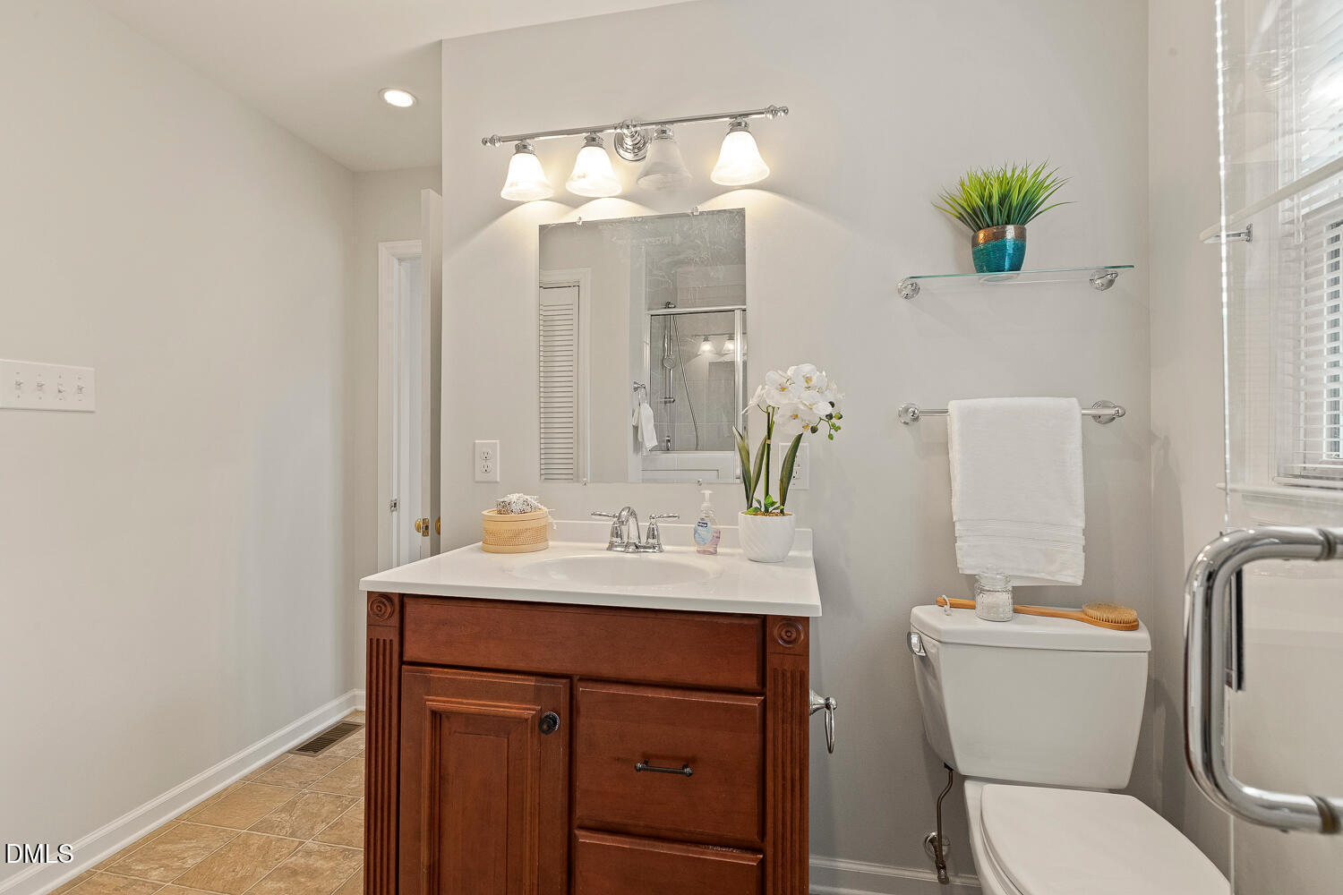 5401 Kaplan Drive Raleigh, NC 27606 - Photo 20 of 41 a bathroom with a sink vanity mirror and toilet