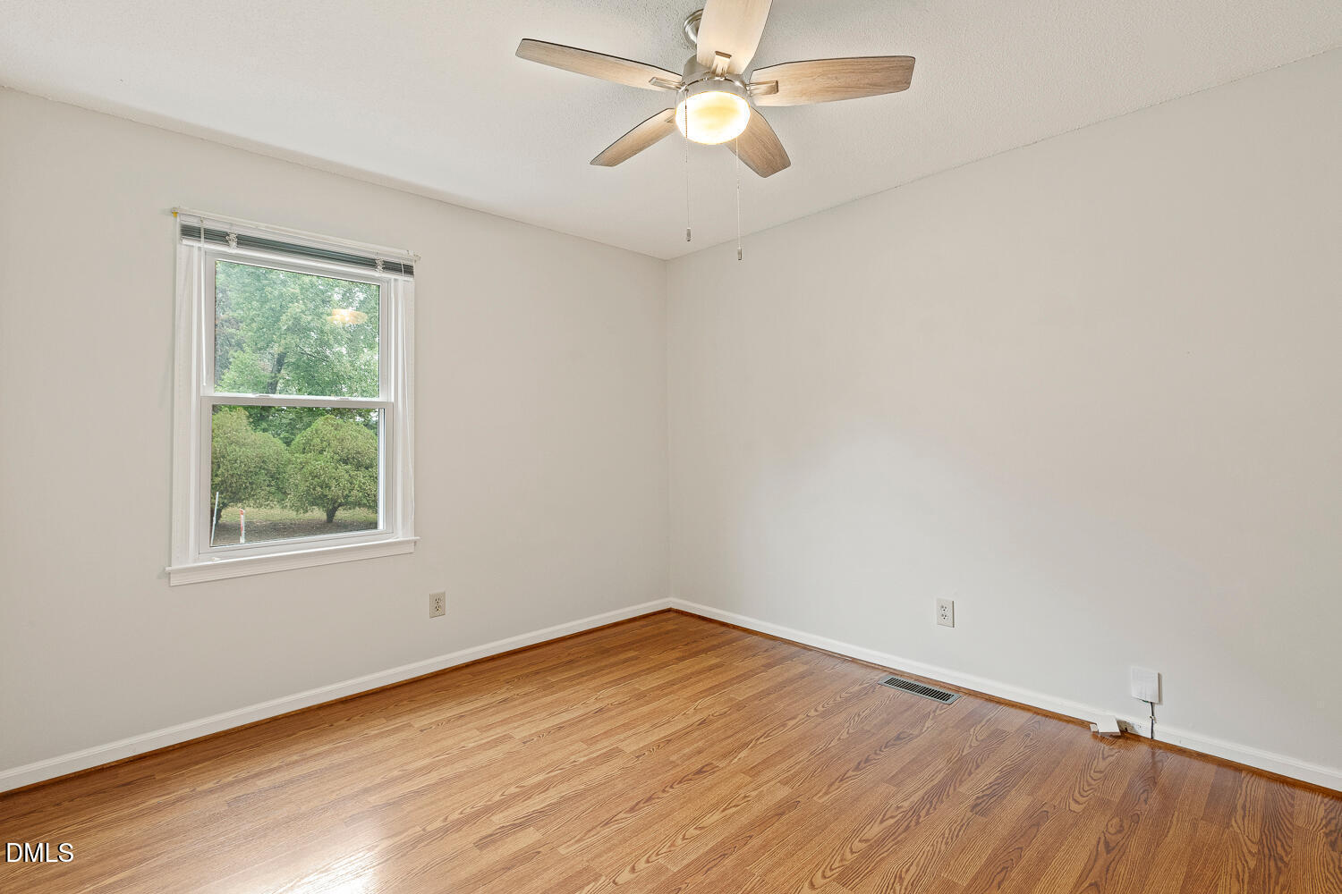 5401 Kaplan Drive Raleigh, NC 27606 - Photo 21 of 41 an empty room with a window and ceiling fan