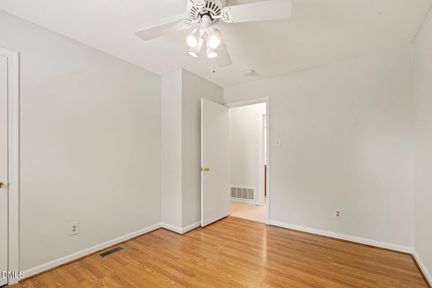 5401 Kaplan Drive Raleigh, NC 27606 - Photo 25 of 41 a view of an empty room with wooden floor