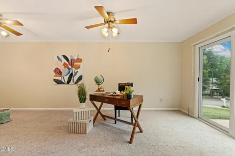 a workspace room with furniture and a window