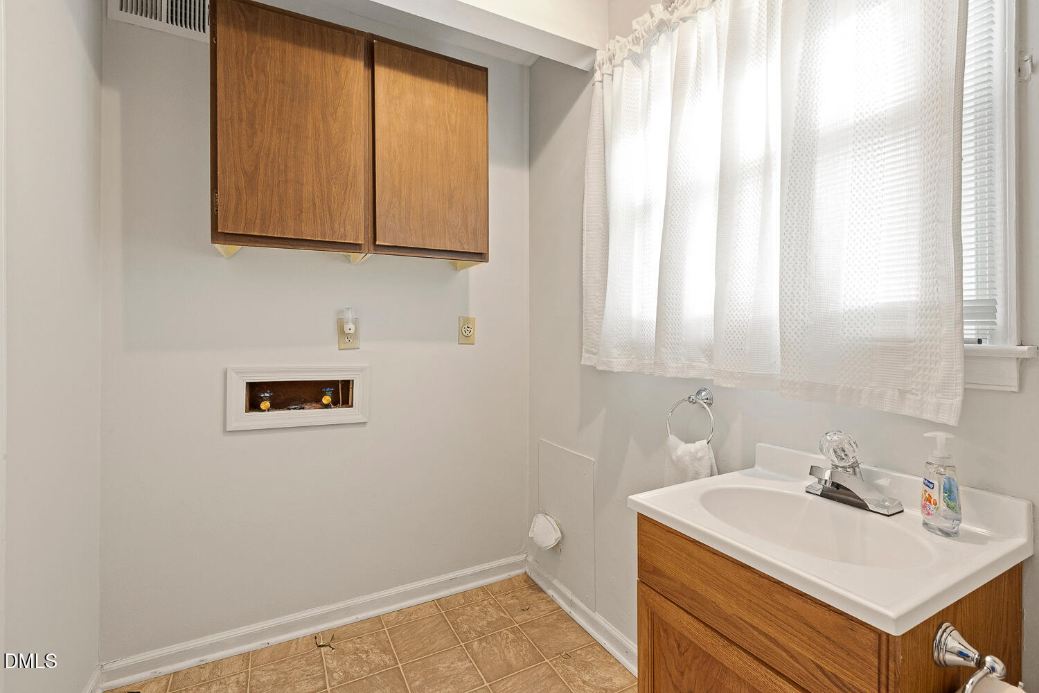 5401 Kaplan Drive Raleigh, NC 27606 - Photo 35 of 41 a bathroom with a sink a vanity and a mirror