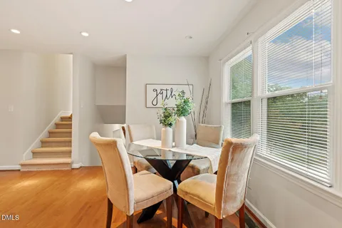 a dining room with furniture and kitchen view