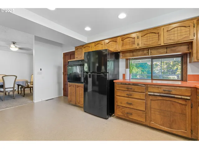 a kitchen with stainless steel appliances granite countertop a refrigerator a sink a stove a microwave and island