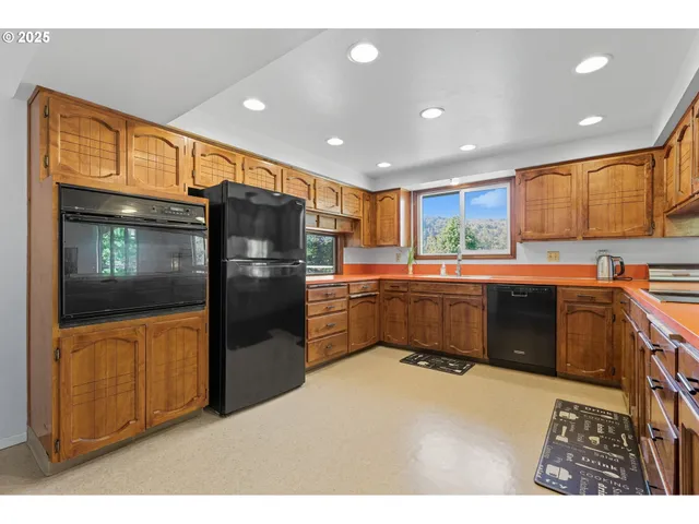 a balcony with stainless steel appliances kitchen island granite countertop a refrigerator and a stove