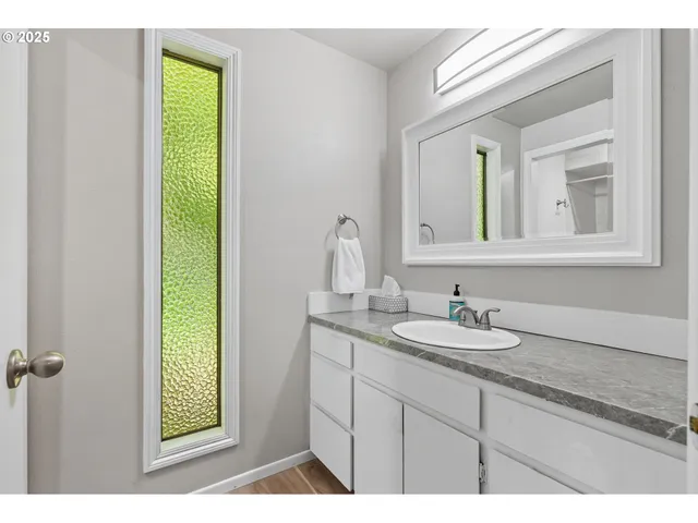 a bathroom with a shower and a sink