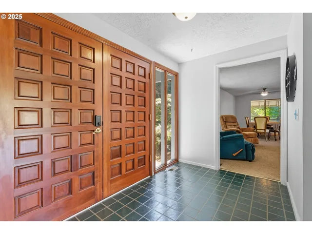 a view of an entryway with wooden floor