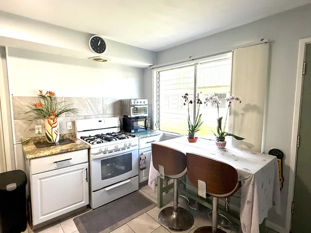 a kitchen with a stove a sink and a refrigerator