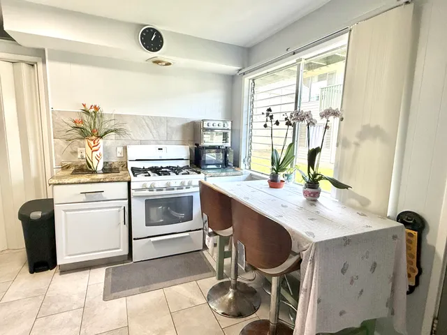 a kitchen with a stove a sink and a refrigerator