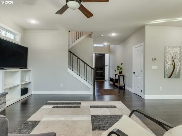 a living room with furniture and a view of kitchen