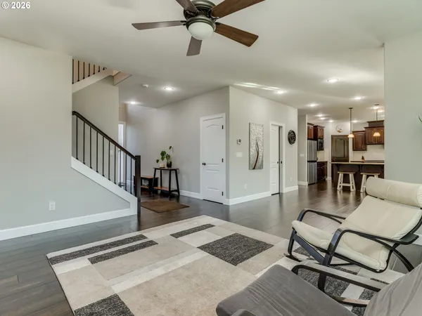 a open kitchen with stainless steel appliances granite countertop a refrigerator and a stove top oven