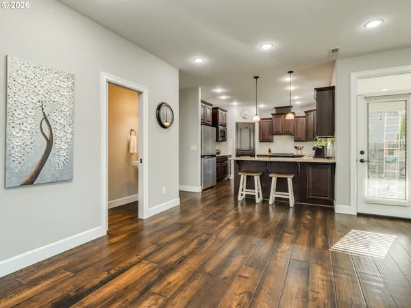 a kitchen with kitchen island a sink stove and refrigerator