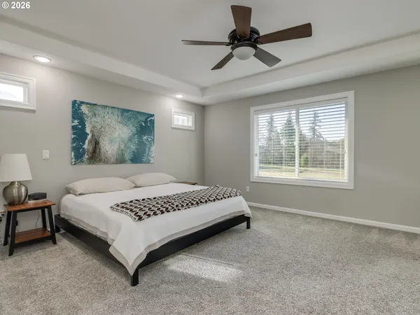 a living room with a flat screen tv and a ceiling fan