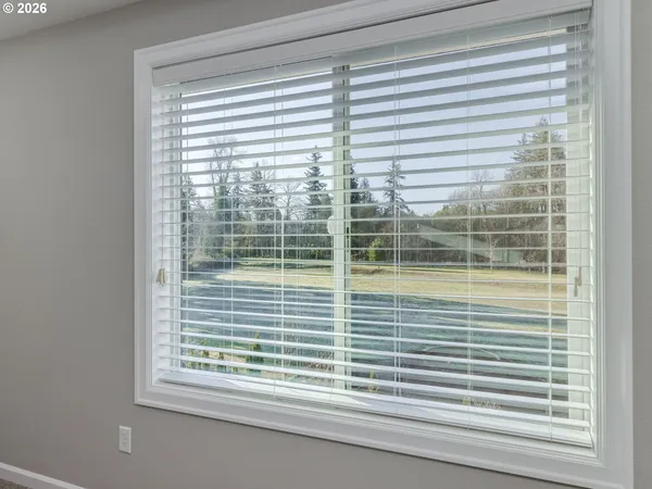 a bathroom with a tub a sink a mirror and a window