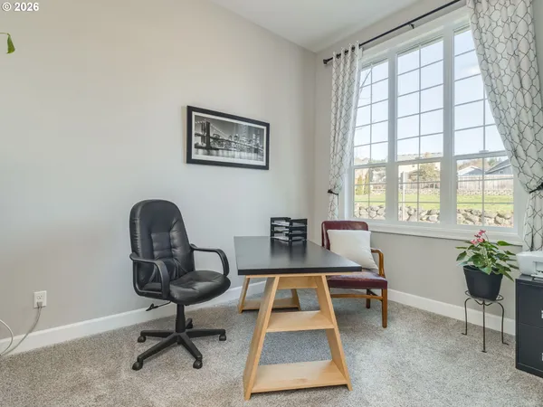 a living room with furniture a window and a fireplace