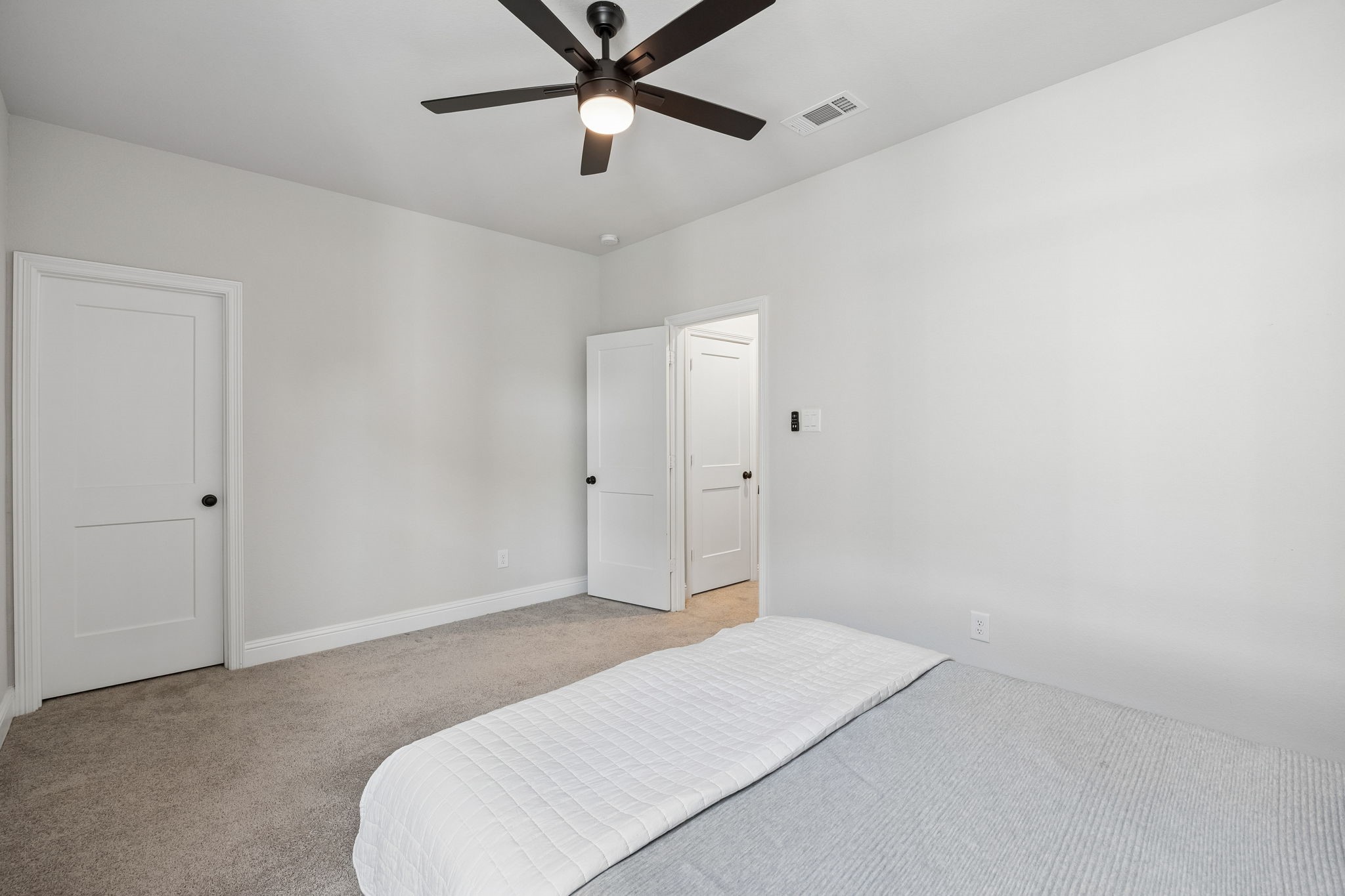 10102 South Goshawk Trail Conroe, TX 77385 - Photo 23 of 46 a bedroom with a bed and a ceiling fan
