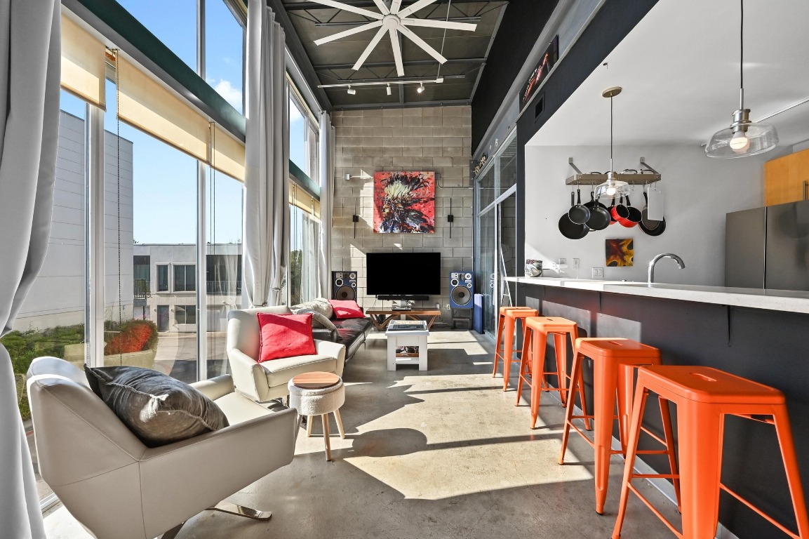 a living room with furniture a flat screen tv and a fireplace