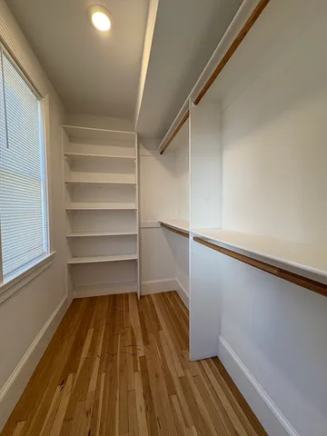a view of a room with wooden floor and staircase