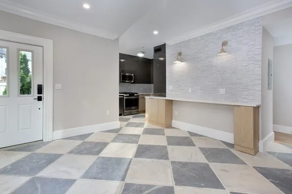 a view of a big room with wooden floor and windows