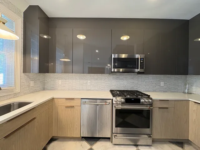 a kitchen with a sink and stainless steel appliances