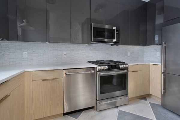 15 Lanark Road, Unit G Brookline, MA 02445 - Photo 6 of 30 a kitchen with granite countertop cabinets stainless steel appliances and wooden floor