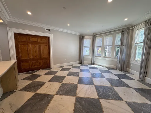 a black and white checkered floor with a rug