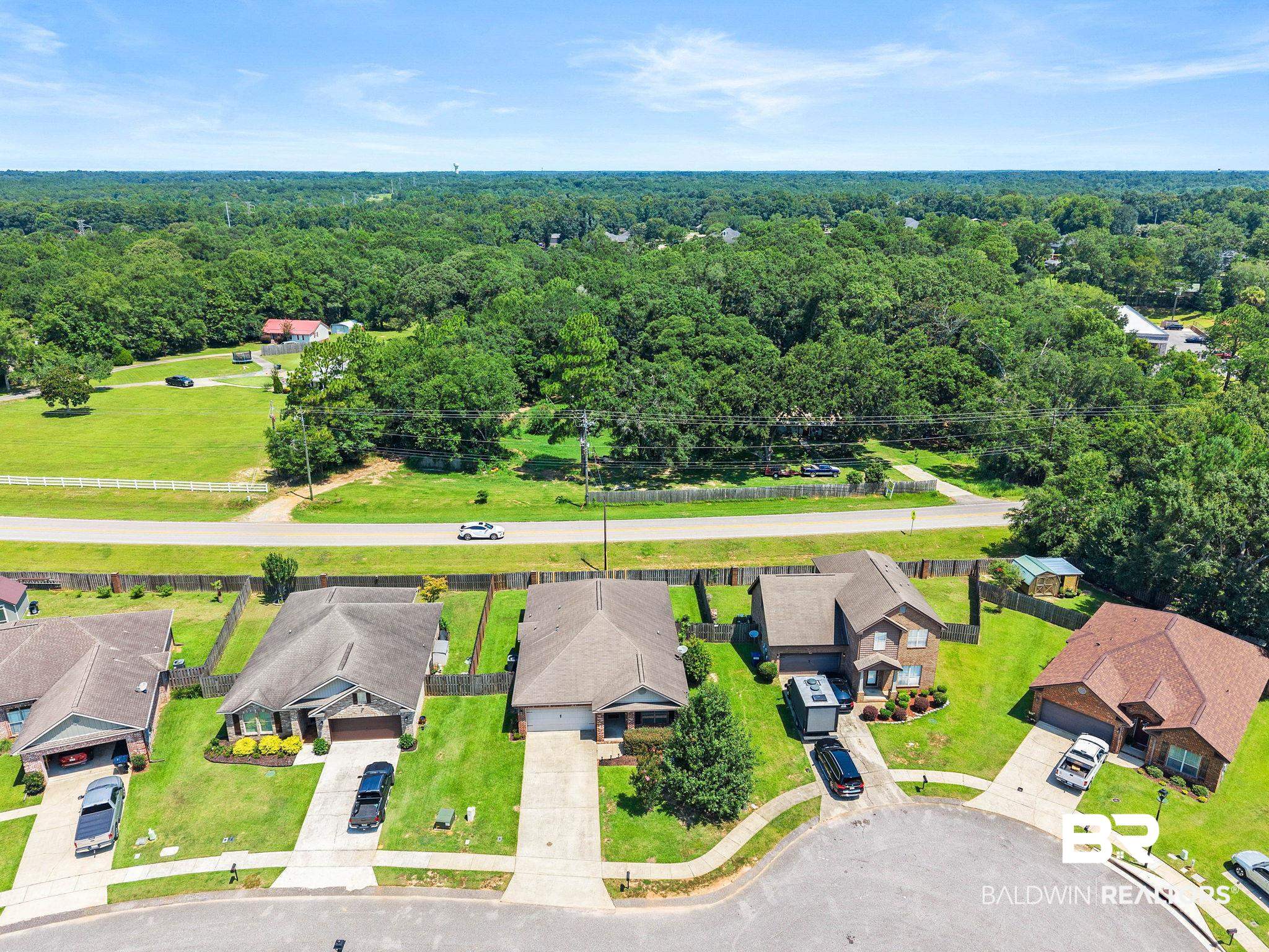 2216 Livingstone Court Mobile, AL 36695 - Photo 50 of 62 Residential property featuring a paved driveway, attached garage, and manicured landscaping