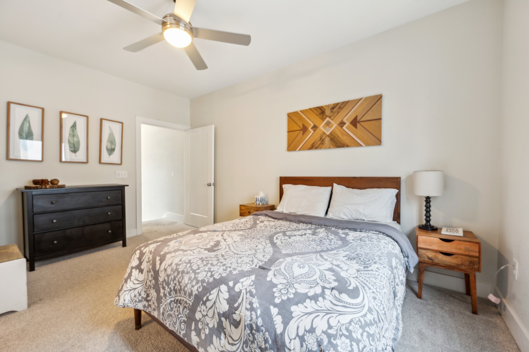 2827 Manor Road, Unit 3104 Austin, TX 78722 - Photo 11 of 30 A comfortable bedroom with soft carpeting and a ceiling fan for year-round comfort.