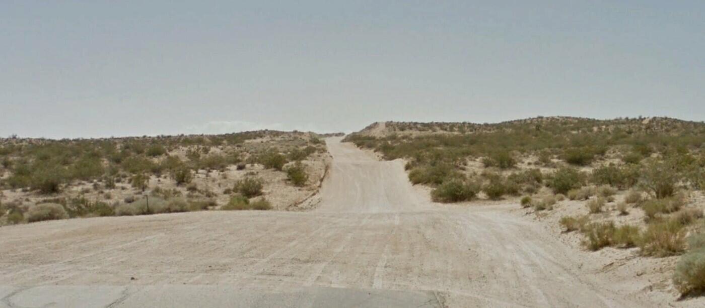 Clark Street Mojave, CA 93501 - Photo 8 of 17 a view of a dry yard with mountains in the background