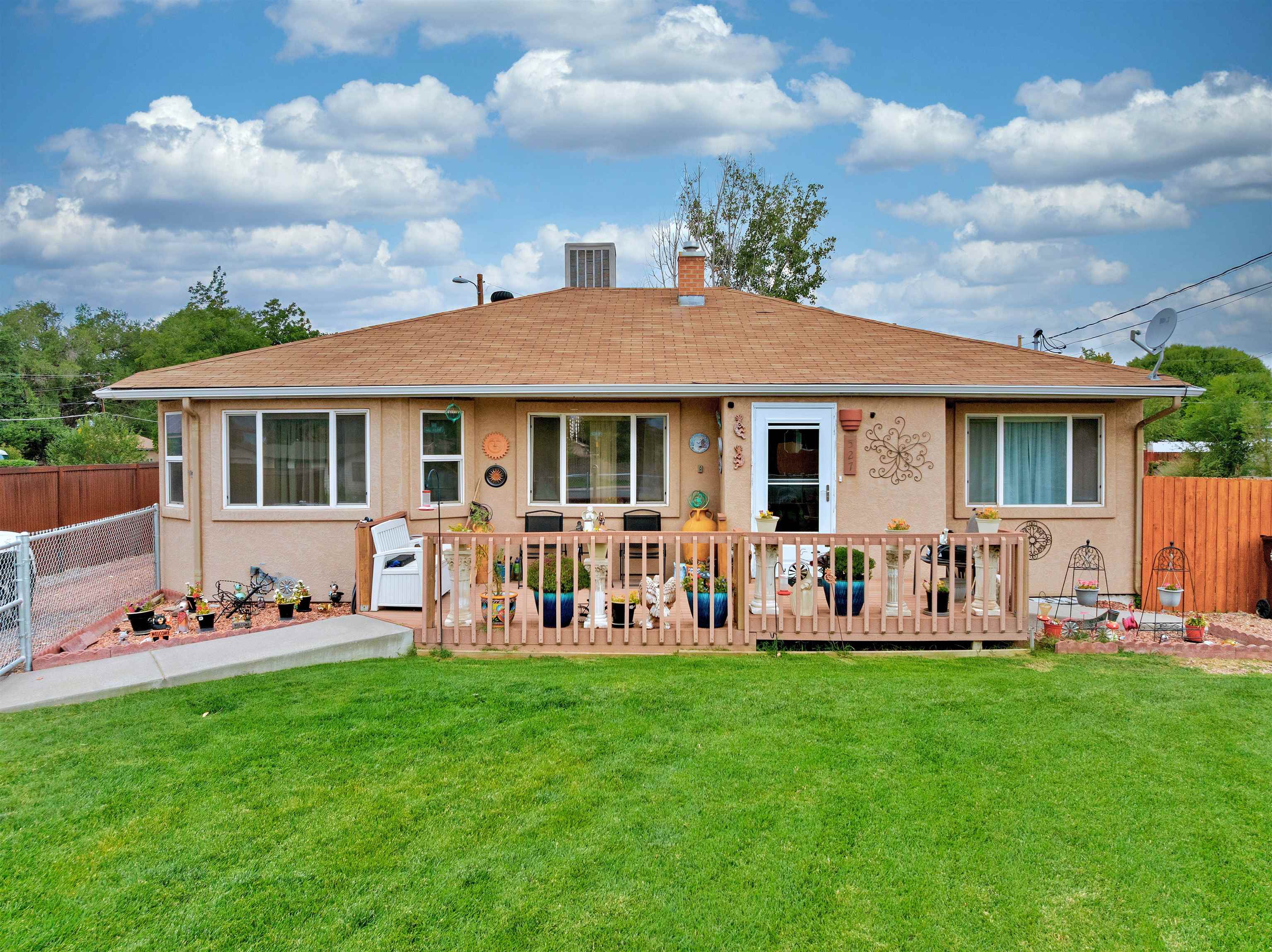 a front view of a house with garden with outdoor seating