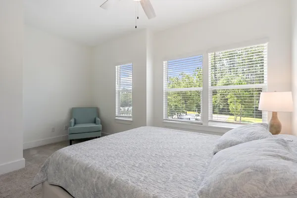 a bedroom with a bed and a lamp