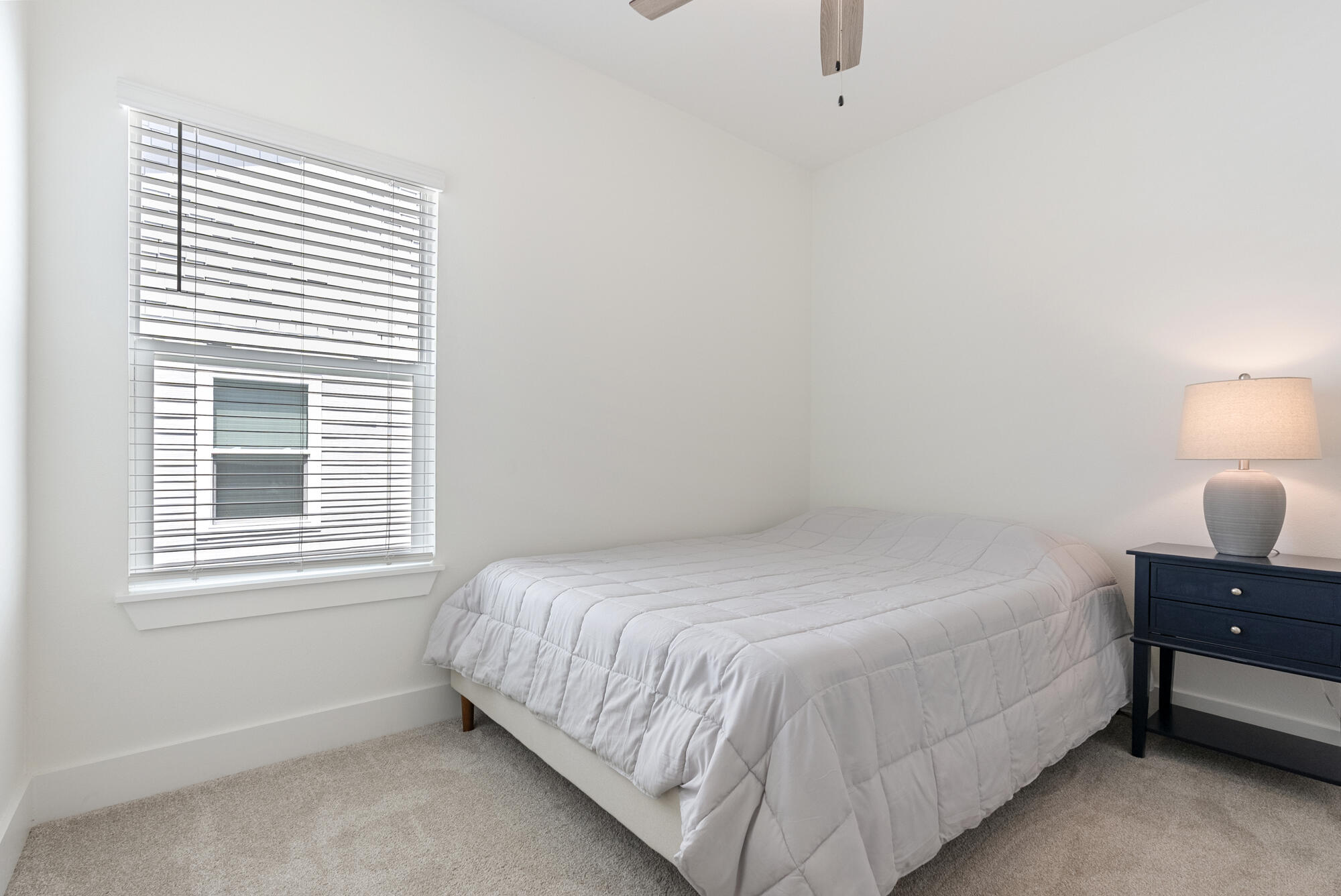 36 Date Palm Lane Freeport, FL 32439 - Photo 19 of 26 a bedroom with a bed and window with lamp