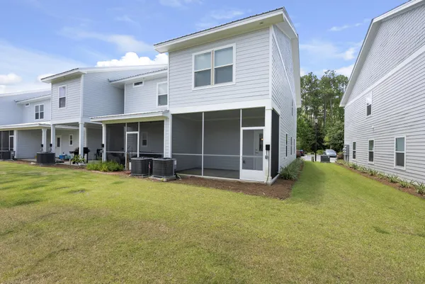 a view of a house with a yard and sitting area