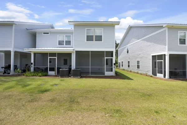 a view of a house with a yard and sitting area
