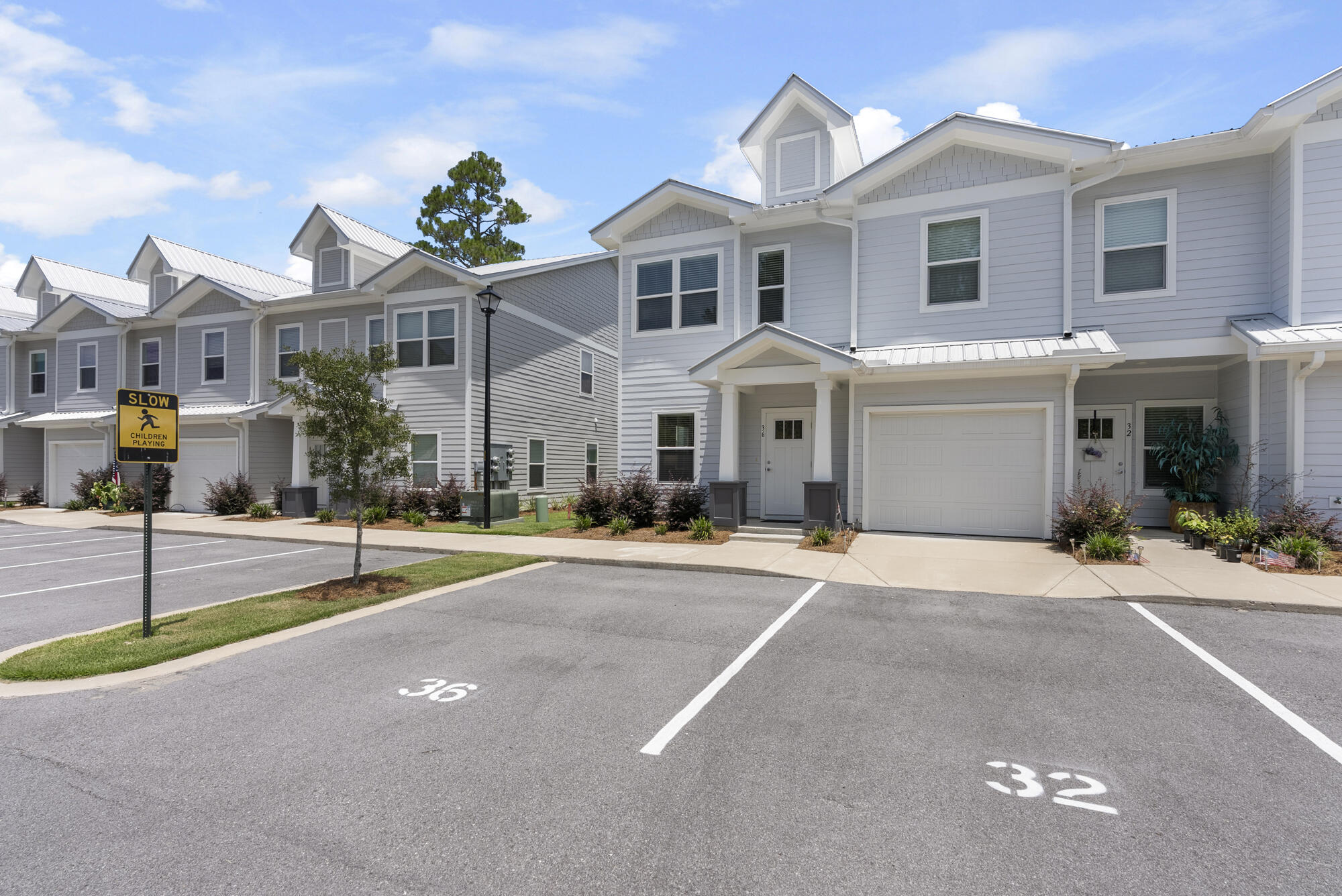36 Date Palm Lane Freeport, FL 32439 - Photo 3 of 26 a front view of a house with a garden and tree