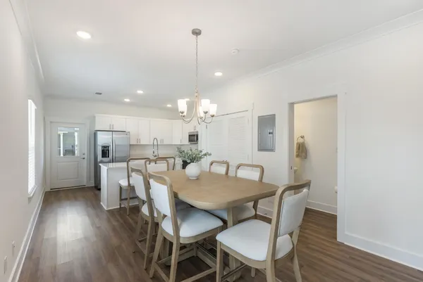 a view of a dining room with furniture and wooden floor