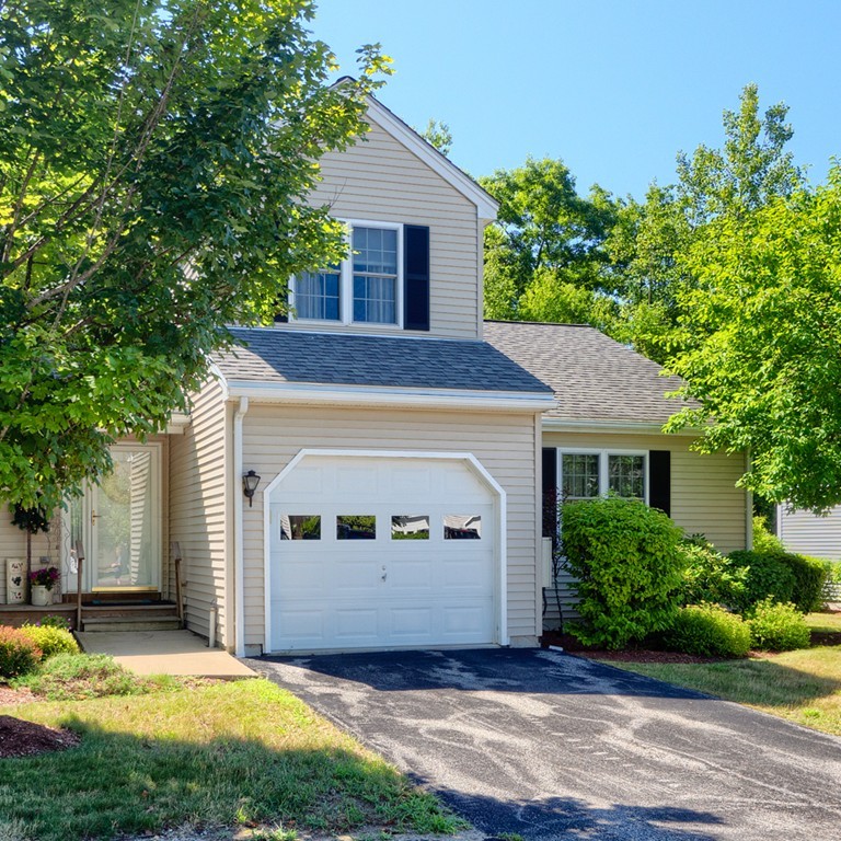 125 Shire Road, Unit 40 Leominster, MA 01453 - Photo 1 of 29 a front view of a house with a yard and garage