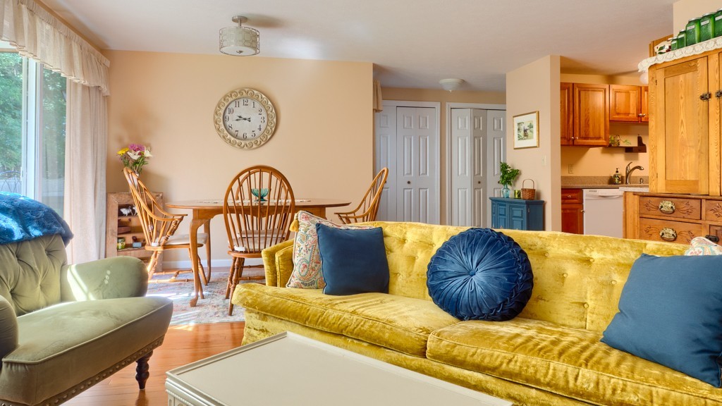 125 Shire Road, Unit 40 Leominster, MA 01453 - Photo 6 of 29 a living room with furniture a clock on wall and a window