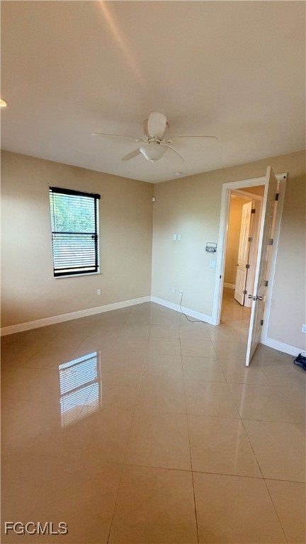 4310 4th Street Southwest Lehigh Acres, FL 33976 - Photo 11 of 27 an empty room with windows and fan