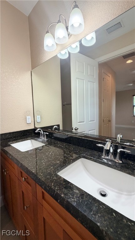 4310 4th Street Southwest Lehigh Acres, FL 33976 - Photo 13 of 27 a bathroom with a sink and a mirror