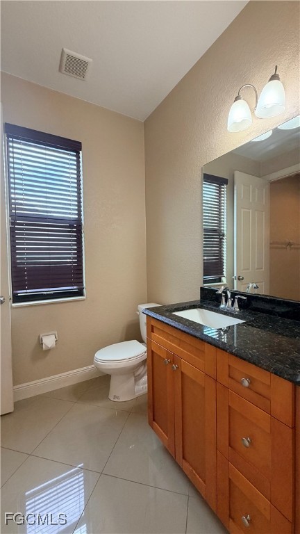 4310 4th Street Southwest Lehigh Acres, FL 33976 - Photo 16 of 27 a bathroom with a toilet a sink and mirror