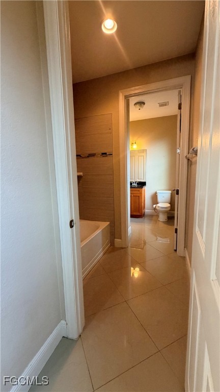 4310 4th Street Southwest Lehigh Acres, FL 33976 - Photo 19 of 27 a view of a bathroom from a hallway